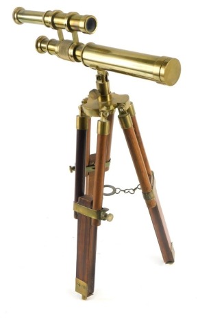 A replica brass telescope, with adjustable hardwood tripod, the telescope 29cm long.