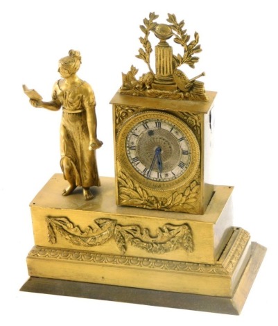 A French gilt metal and figural mantel timepiece, composed of a lady with a book beside clock with silvered dial, the rectangular base applies with swags, etc., 20cm high, 18cm wide.