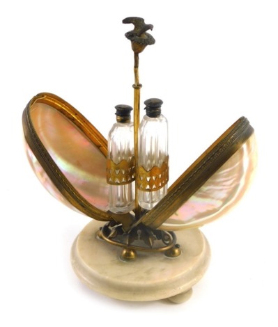 A 19thC Continental and gilt metal shell and marble scent bottle holder, of egg form on bun feet, 22cm high.
