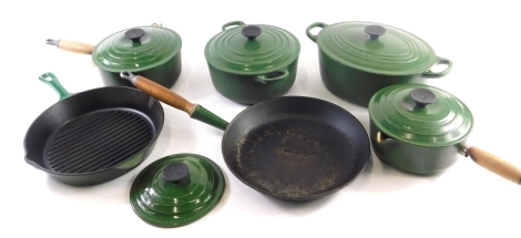 A collection of green enamel Le Creuset pans, to include oval casserole dish, skillet, etc.