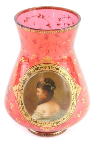 A Bohemian ruby tinted glass vase, with applied plaque painted with a lady in profile, within gilt leaf borders (AF), 16cm high.