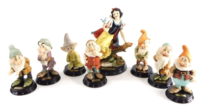 Various Giuseppe Armani Snow White and The Seven Dwarfs figures, to include Snow White, 32cm high, fronted with plaque, on wooden base. (8, boxed)