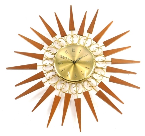 A Paico teak gilt metal sun burst wall clock, 52cm wide.