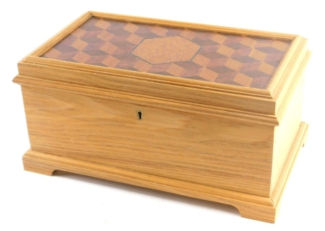 A teak and cubed parquetry jewellery box, the galleried lid with central oak hexagonal cartouche, 41cm wide.