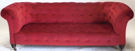 A Victorian walnut Chesterfield sofa, with red buttoned upholstery, 200cm wide.