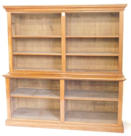 A Victorian satin birch and walnut open bookcase, with moulded cornice, adjustable shelves to the upper and lower part, on plinth, 195cm high, 195cm wide, 52cm deep.