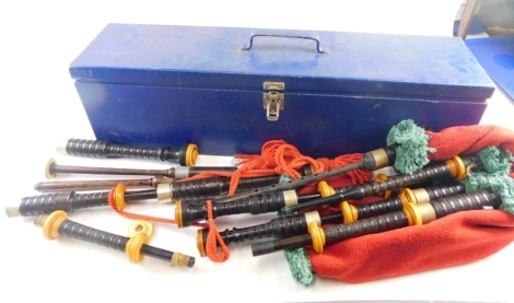 A set of 20thC bagpipes, with brass fittings and turned sections, in a fitted case with tartan lining, the case 69cm long. (AF)