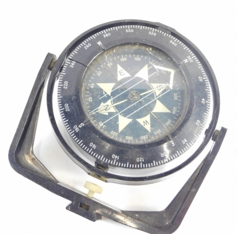 A metal cased ship's compass, with white stencilled Arabic dial, in plastic casing.