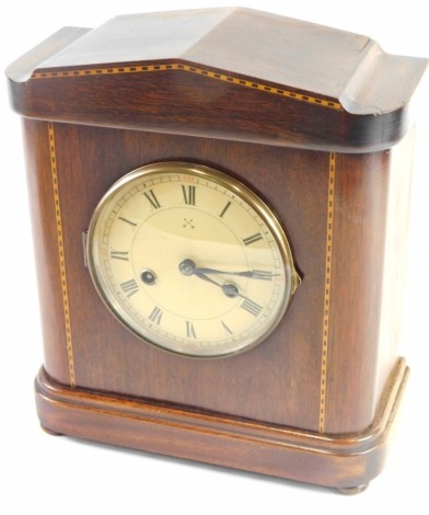 A Edwardian inlaid mantel clock, the 13cm diameter Roman numeric and Arabic dial in an architectural case with a boxwood stringing, with eight day movement, striking on the hour and half hour, 31cm high.