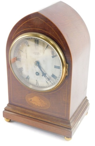 An Edwardian mahogany and inlaid mitre cased mantel clock, the 15cm diameter silvered Roman numeric dial marked W.Burdon Grimsby, in a shell inlaid case on orb feet, with keywind movement, striking on the hour with pendulum, 37cm high.