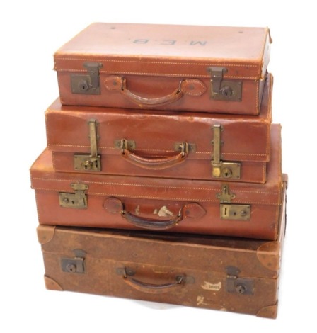 A 20thC Revelation brown leather travel case, with brass mounts initialled MN, 38cm high, 57cm wide, 18cm deep, and three other travel cases. (4)