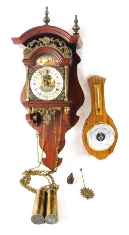 A hanging barometer and a Dutch Zaanse style clock, with Roman numeric dial, 51cm high.