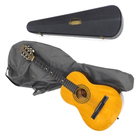 An Encore acoustic guitar, ENC36N, with JSH label, 91cm long, canvas case, and a vacant violin case. (2)