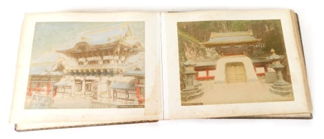 An early 20thC Japanese lacquered photograph album, containing a quantity of photographic prints of Japanese scenery, to include Nagasaki, printed in colours, 22cm x 27cm.