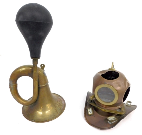 A 20thC brass car horn, with rubber end and a miniature copper and brass diver's helmet, 20cm high. (2, AF)