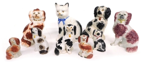 Various Staffordshire pottery spaniels, standing cat with blue bow, the body picked out in black, 44cm high, various Staffordshire spaniels, etc. (a quantity)