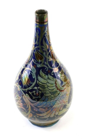 A late 19thC Pilkington's Royal Lancastrian lustre pottery vase, of globular form, decorated with Griffin scrolls and flowers, in silver, blue and brown colours, on circular foot, initialled with impressed marks beneath, 23cm high. (AF)