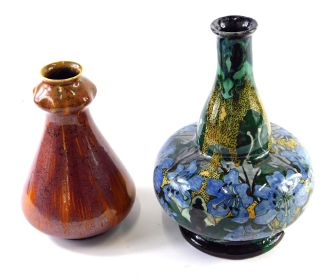 An early 20thC Art Nouveau pottery vase, of tapering form, on circular foot, no.2207A, impressed marks beneath, 18cm high and a Hibbo pottery vase marked NB beneath, profusely decorated with flowers on a green ground. (2, AF)