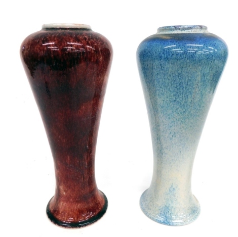 A matched pair of 20thC Cobridge pottery vases, one in blue speckled decoration, the other red speckled, marked beneath, 31cm high. (2)