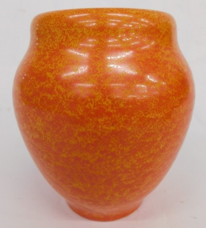 A Royal Lancastrian pottery orange vase, by Radford, vibrantly decorated with a speckle glaze, on circular foot, impressed marks beneath, 15cm high.