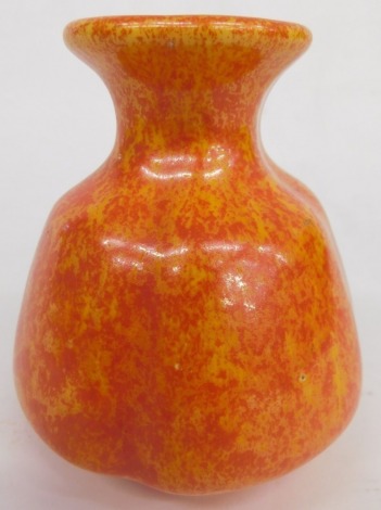 An early 20thC Royal Lancastrian Radford style orange vase, vibrantly decorated with speckle glaze, impressed marks beneath, 12cm high.