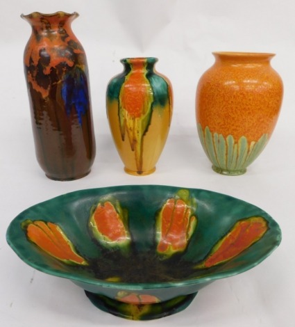 An early 20thC Uranium type dripware vase, in speckled orange and green pattern, unmarked, 26cm high, and various other similar glazed vases, one marked England, trumpet shaped vase, etc. (a quantity AF)