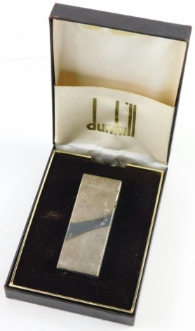 A 20thC Dunhill plated fuel filled pocket lighter, with an engine turned geometric design, 7cm high, in outer case.