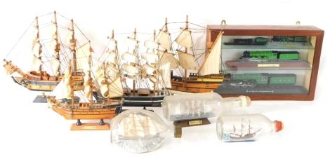 A cased OO gauge LNER Flying Scotsman with tender, on wooden plinth base, 5cm high, and two others, in single case, various models of famous ships, HMS Bounty, Mayflower, Cutty Sark, a Dimple ship in a bottle, HMS Victory, etc. (a quantity)