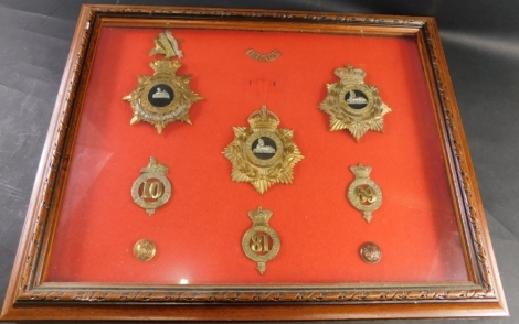 A case of various Lincoln brass cap and other badges, an Soit Qui Mal Sphinx badge, 13cm high, North Lincoln Regiment badge, brass button, Lincoln Volunteers 81 badge, South Lincolnshire 69 badge, various others, etc. (1 case)