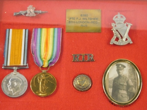 A cased World War I medal group, comprising Campaign and Victory medals, button and rifle badge, in case marked PTE F J WILTSHIRE 8350 8th London Reg RIR, 26cm x 28cm.