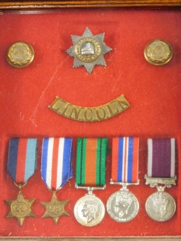 A cased miniature World War II medal group, with Lincolnshire badges, the case 21cm x 18cm.