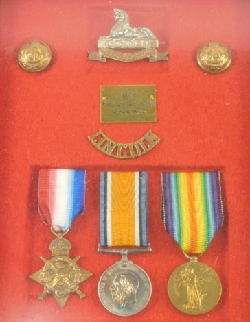 A World War I cased medal group, comprising 1914-15 Star, Campaign medal and Victory medal, with cap badges, in case marked 1624 PTE L.V.Stocks Lincs Regiment, the case 31cm x 25cm.