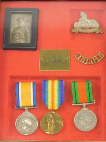 A WWI and WWII part medal group, comprising Campaign and Victory medals, and a further WWII medal, Lincoln cap badge and photograph, in case marked 45974 PTE S Hill Lincolnshire Regiment 1914-18, the case 31cm x 26cm.