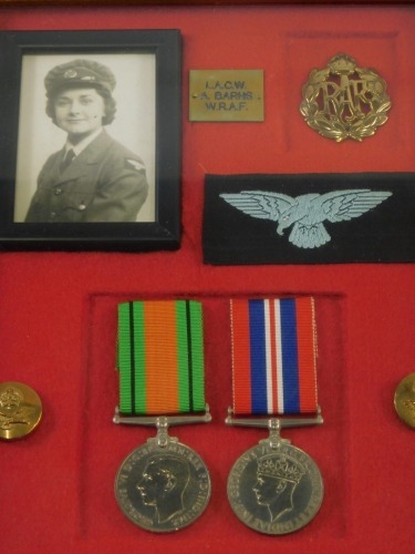 A WWII medal group, comprising Campaign and Victory medals, with RAF badge and buttons, and photograph of a lady, in case marked LACW A BARNS WRAF, the case 32cm x 26cm.