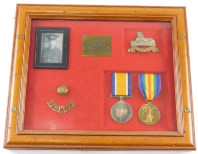 A WWI medal group, comprising Campaign and Victory medals, Lincoln shoulder badge, brass button, and Lincoln Sphinx badge, with photograph, in case marked 36960 PTE A SHERIFF Lincs Reg, the case 25cm x 31cm. - 2