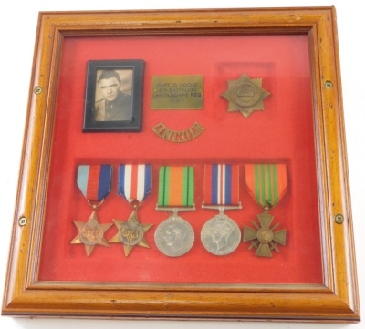 A cased WWII medal group, comprising 39-45 and France and Germany Stars, Campaign and Victory medals, and a cross, with red and green ribbon, Lincoln Regiment badge and photograph, in case marked CAPT D. COOKE Fourth Battalion Lincolnshire Reg W.W.II, the - 2