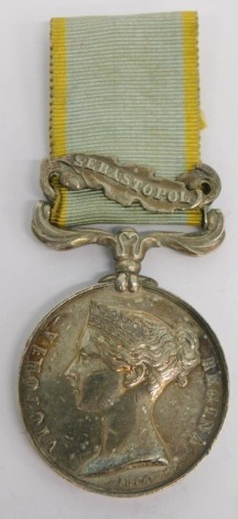 A Victorian Crimea medal, marked GUNR C CHAPLIN RA, the ribbon with Sebastopol clasp.