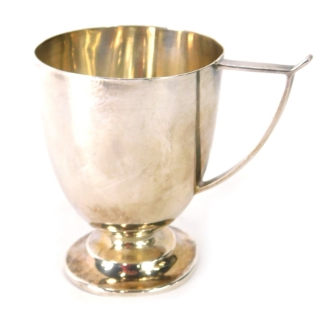 A George V silver christening cup, with angular wishbone shaped handle, and a domed foot, Sheffield 1926, 2.9oz, 8cm high.