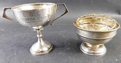 A George V silver two handled trophy cup, engraved E.G.C George cup momento first div 1946, London 1929 and a small rose bowl cup engraved Perivale Park golf club special prize 1941 HA Parry with a brass flower arranger, 2.06oz overall.