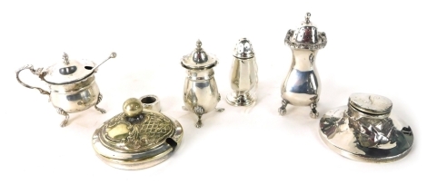 A collection of small silver, etc., to include mustard pot, three pepper pots, and a damaged capstan inkwell, silver plated lid, etc.