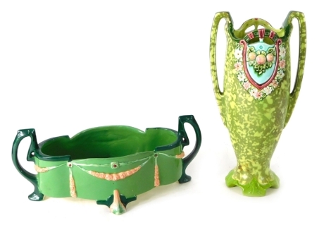 An Austrian Wahliss style secessionist pottery vase, raised with berries and garlands flanked by angular handles, on a green ground, impressed mark beneath, 33cm high, and a further Eichwald style pottery dish, with angular handles raised with moulded gar