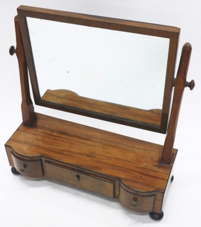 A 19thC mahogany and ebonised table mirror, the rectangular plain glass raised above an arrangement of three drawers, on orb feet, 50cm high, 51cm wide, 19cm deep.