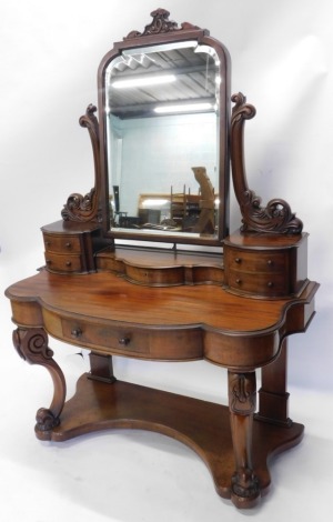 A Victorian mahogany Duchess dressing table, the bevel glass flanked by heavily carved scroll supports, with four D end drawers, above a frieze drawer, on heavily carved legs joined by an under tier, 174cm high, 114cm wide, 54cm deep.