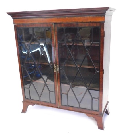 A late 19thC mahogany and inlaid freestanding bookcase, with astragal glazed doors, on splayed feet, 128cm high, 114cm wide, 42cm deep.