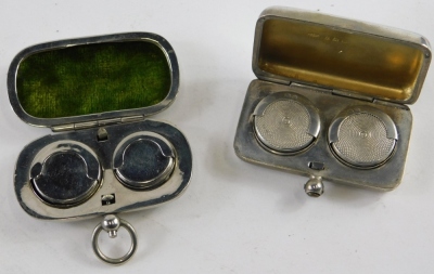 A George V silver double sovereign case, of oblong form with double spring loaded interior, Birmingham 1911, 6cm wide, 1.4oz, and a silver plated double sovereign case. (2)
