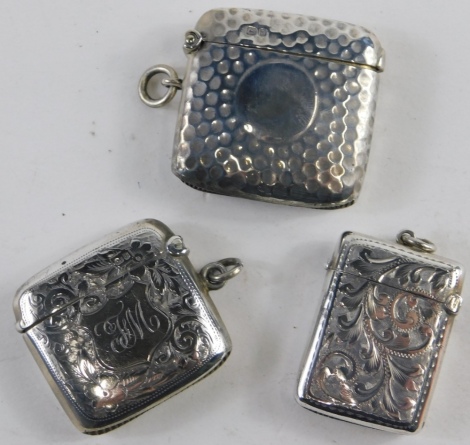 Three various small Vesta cases, to include Edward VII with plain shield escutcheon, scroll decoration, plain ring top and match strike base, 4cm high, another hammered silver Vesta case, etc., 1.8oz. (3)