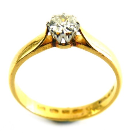 A diamond solitaire ring, set with round brilliant cut diamond, approximately 0.30 carat, in a claw setting, on a yellow metal band, with rubbed hallmarks, possibly 22ct gold, ring size M, 3.4g all in.