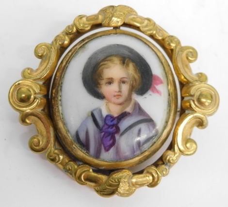 A 20thC portrait pendant brooch, centred with an enamelled style portrait of a child, 3cm x 3cm, in a scroll surround, with a vacant open glazed section for lock of hair, and plain pin back, in a Swarovski box.