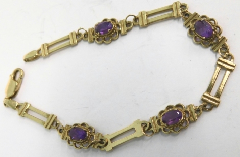 A 9ct gold fancy link bracelet, set with amethyst coloured stones, marked 375, 19cm long, 6g all in.