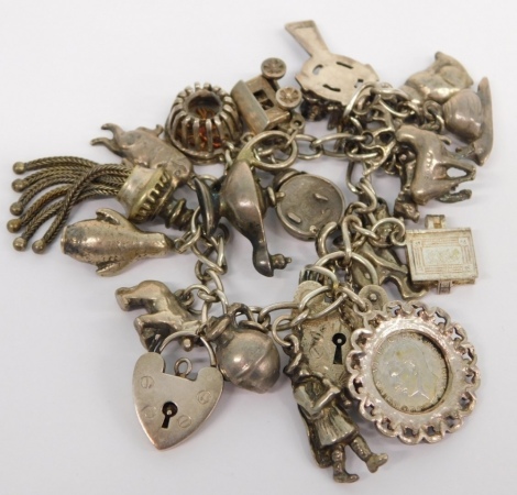 Various sterling and other charms, to include snail, 1cm high, on a bracelet with heart shaped clasp, 2.74oz all in.